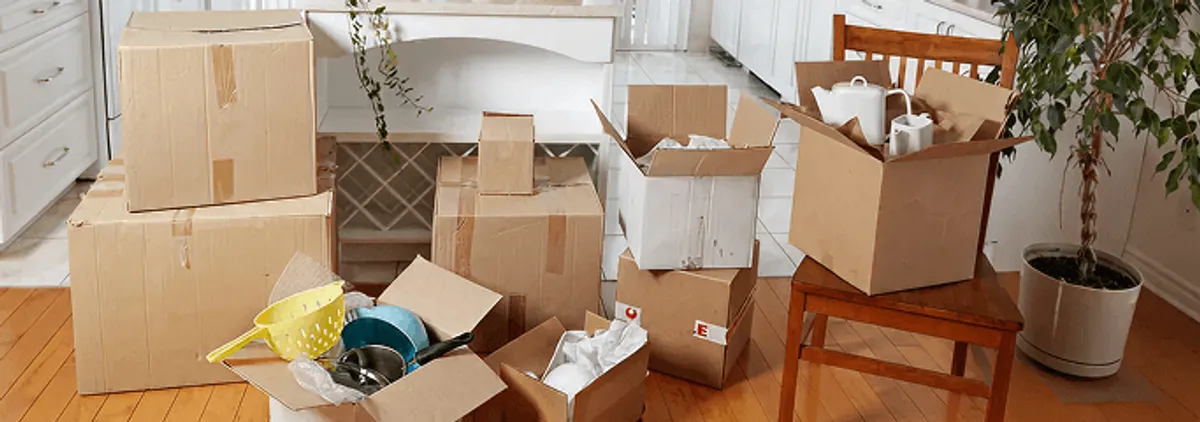Packed moving boxes and household items in a kitchen before move-out or move-in cleaning, Tallahassee, FL.